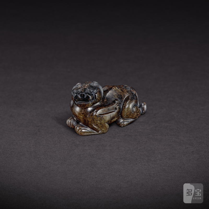 A pale celadon and russet jade mythical beast, Ming dynasty | 明 青白玉瑞獸